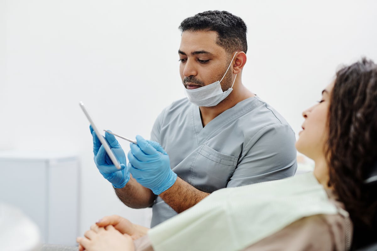 Physician reviewing digital health records with AI-assisted technology in clinical setting